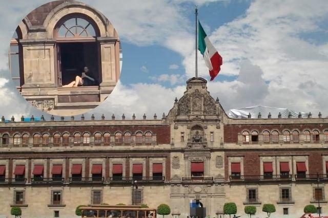 Palacio Nacional y en una ventana una mujer tomando el sol