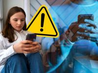 Persona con celular en la mano y símbolo de alerta 